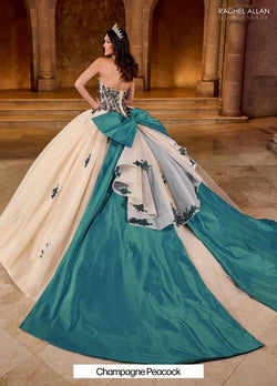 The gown features a strapless sweetheart neckline and a richly decorated bodice adorned with intricate beading, The embroidery extends subtly into the voluminous tulle skirt, Style #: RQ1152